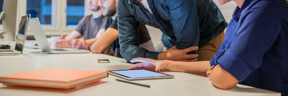 Employees in office using tablet