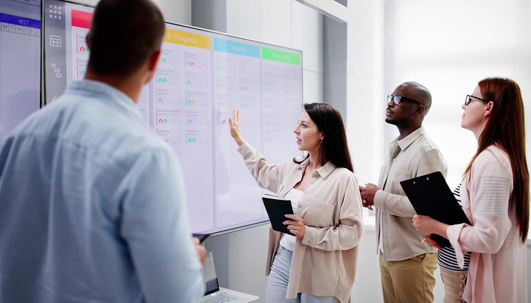 People looking at a board 