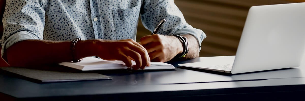 Virtual training model enables rapid onboarding of mechanical services team Person reading and using laptop at a desk