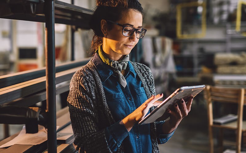 Businesswoman sharing data on tablet computer with colleague 