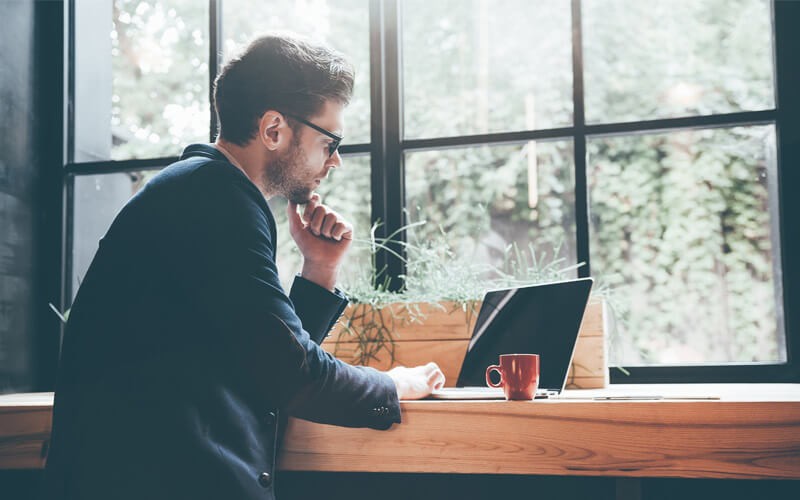 Businessman working on tablet device outside of office