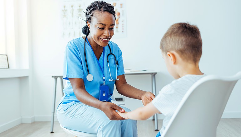 Nurse assesses child patient for illnesses in doctor's office