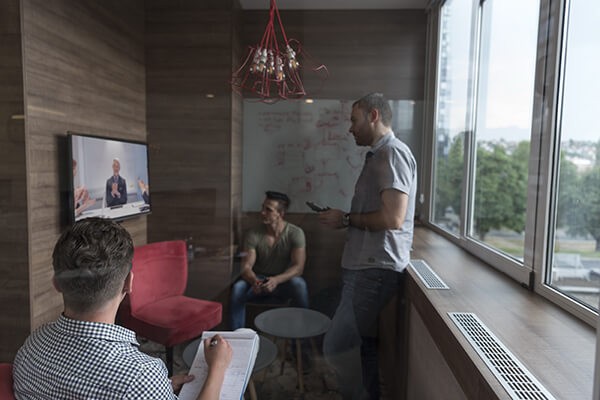 Your Guide to Microsoft Surface Hub Services Group of people in business meeting using surface hub