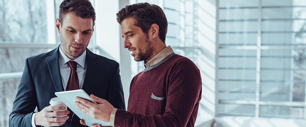 2019 Tech we can’t live without, solutions experiencing growing pains, and what to look forward to in 2020 Two businessmen looking at computer tablet device