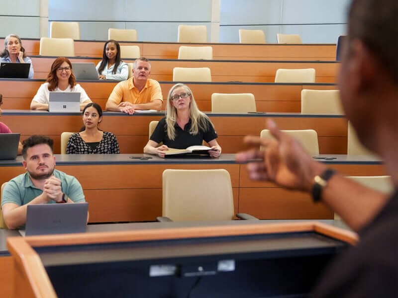 Employees in workgroup session in modern conference room