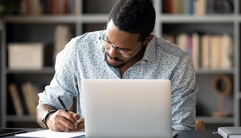 Explore the benefits and strategies behind modern L&D trends to flip the corporate classroom. Business professional taking notes during live virtual training. Flipped classroom Flipped classroom model Flipped classroom case study Virtual training Virtual training company Virtual instructor led training vILT