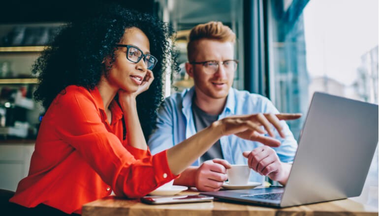 Two business professionals discuss business software licensing offerings. SAM Software Asset Management. 