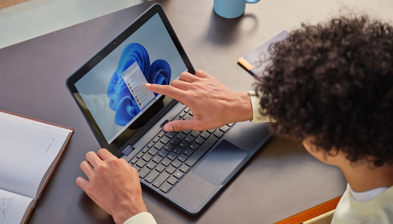 Simplify deployment and management across your entire device fleet Man using laptop for work at home. Windows 11, Device deployment, device manageability, deployment and manageability