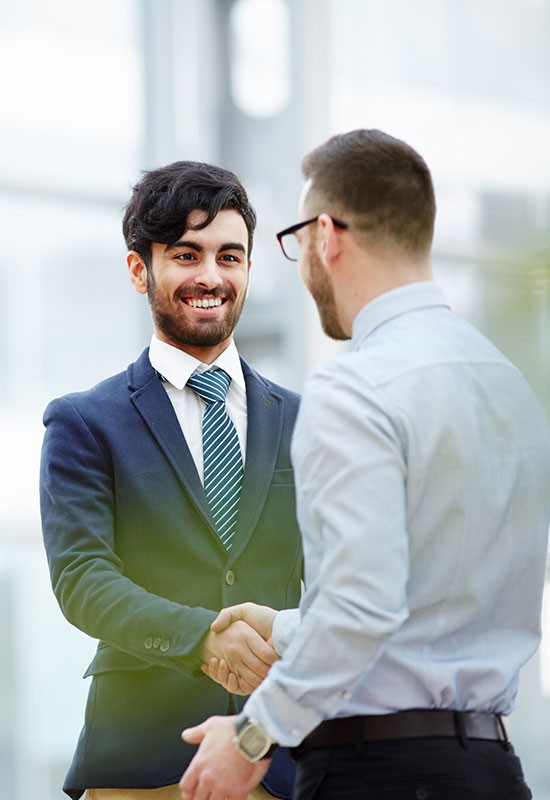 two-male-business-men-shaking-hands-lifestyle-vertical