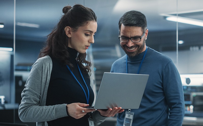 Portrait smiling female and male employee