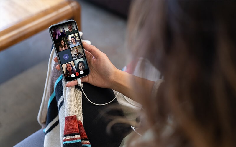 Video meeting solutions you can count on Woman having a meeting using her phone