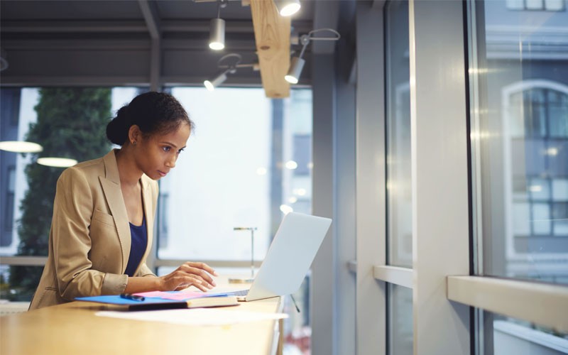 Business woman managing on laptop