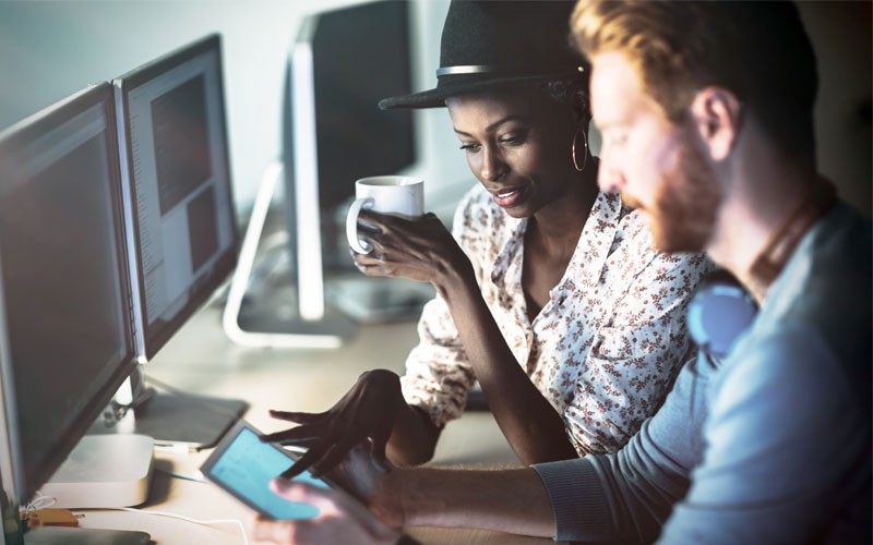 two employees collaborating with tablet