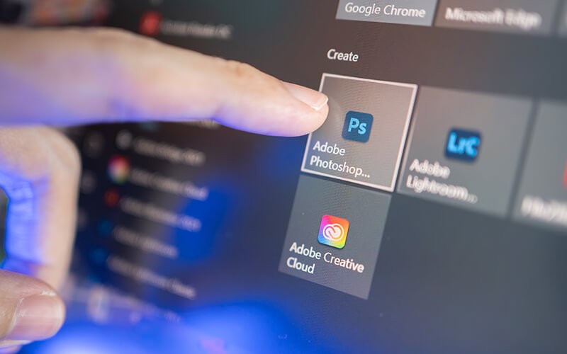 Adobe software solutions User using touch screen device choosing Adobe applications