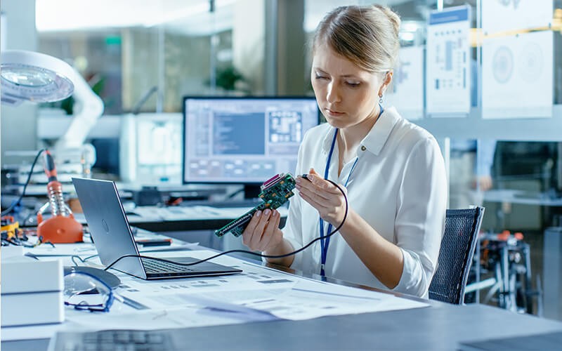 Woman using a laptop with hardware item