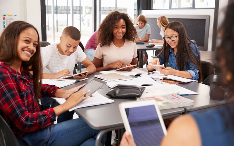 Group of students studying and using apple devices in their studies