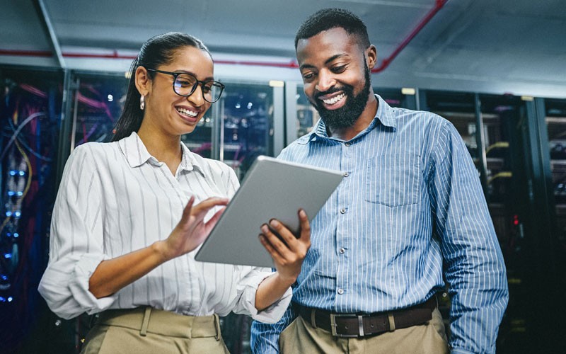 Two IT technicians in server room