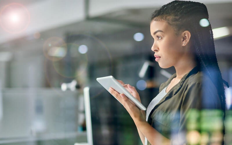 woman-working-on-tablet-looking-up