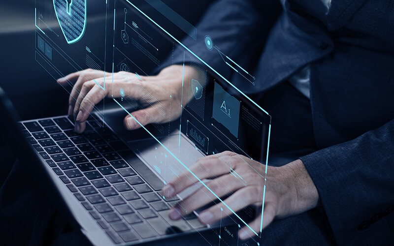 Man typing using laptop