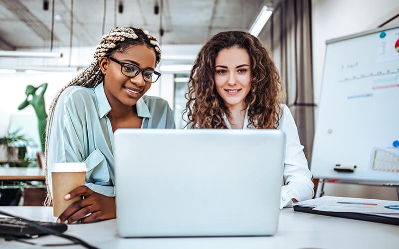 Boost your application performance. Teammates working together using a laptop