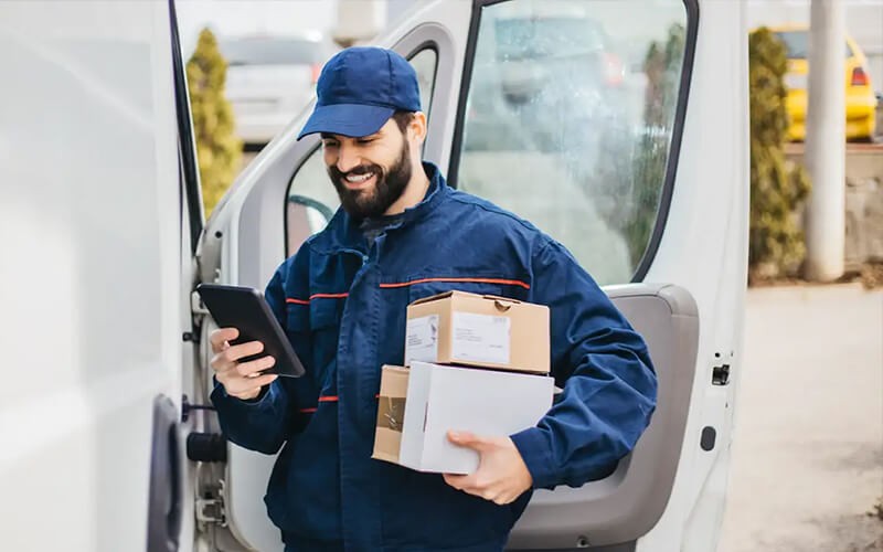 Delivery man smiling while working