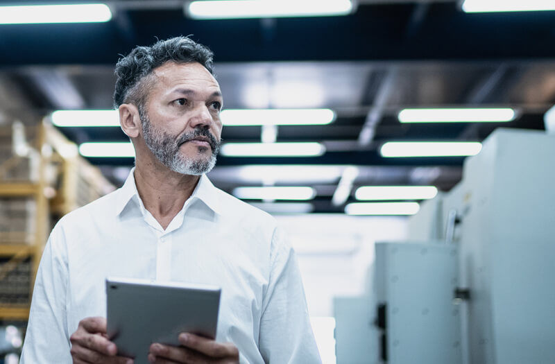 Digital tablet in use in a modern factory for improved efficiency