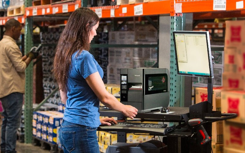 Woman working using a Honeywell printer at work