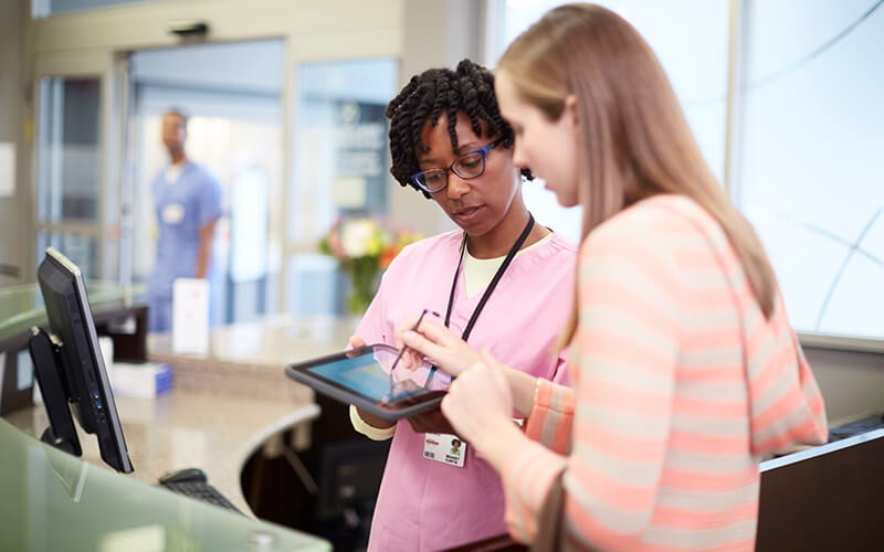 Technology tailored to your industry Nurse with patient using HP healthcare tablet device