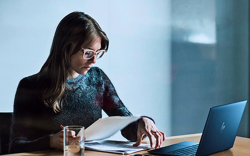 HP Wolf Pro Security Woman working using HP laptop