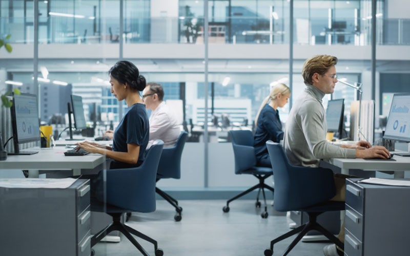 View of business professionals in open office environment