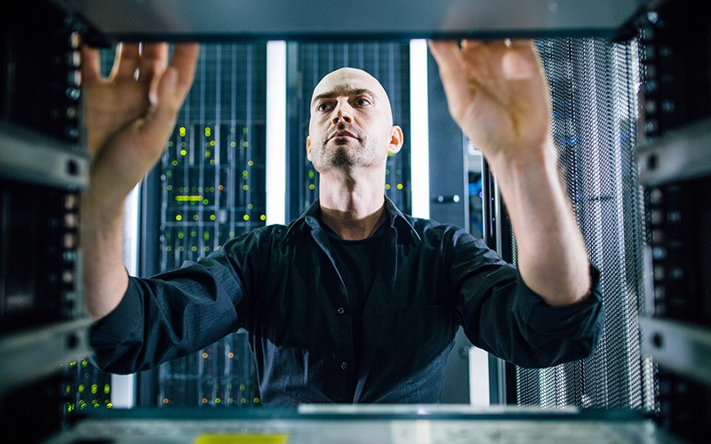 IT technician working on server racks found in data center