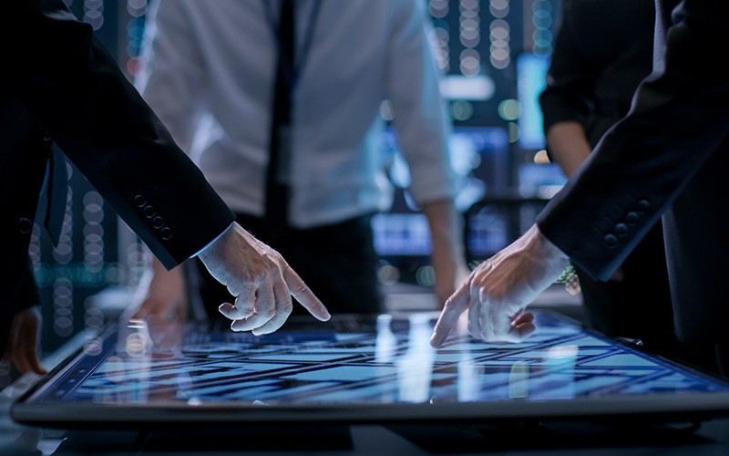 Professionals discussing on a glass pane