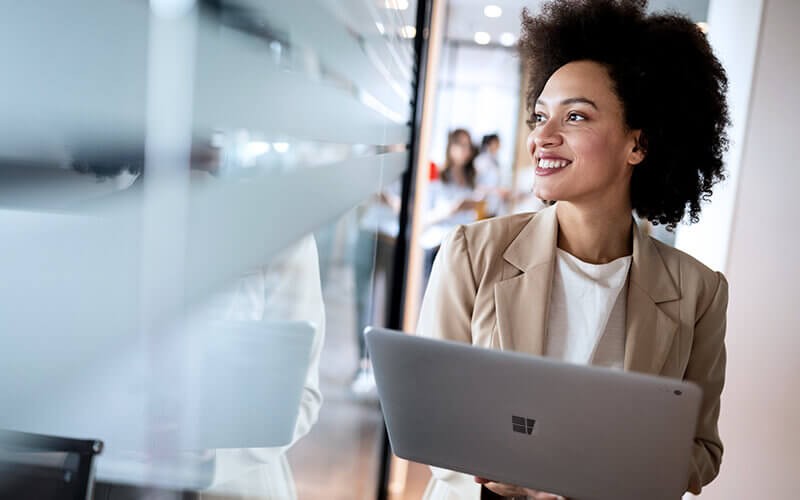 Woman smiling using her laptop