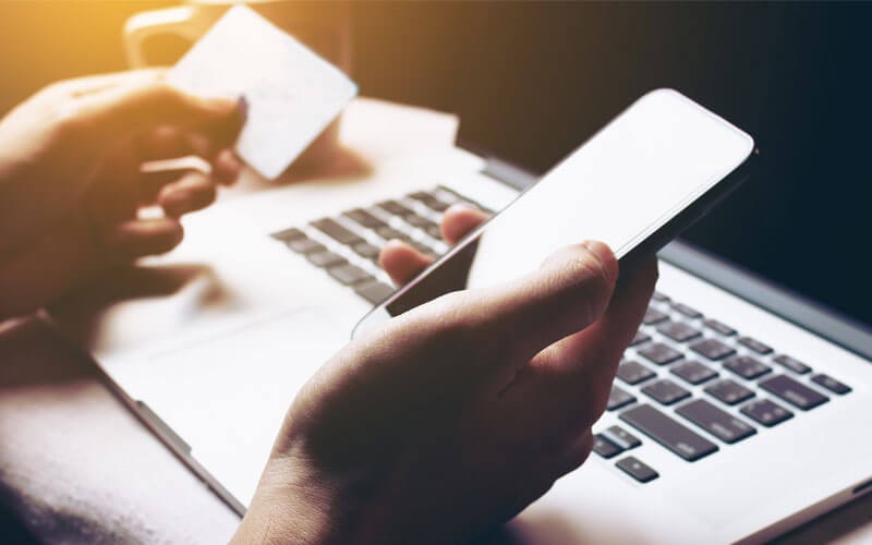 Hands on mobile phone and credit card