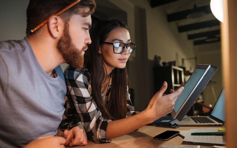 Two people working in office