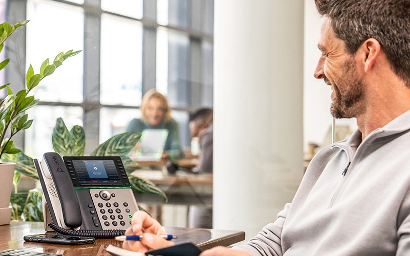 Business man using Polycom phone