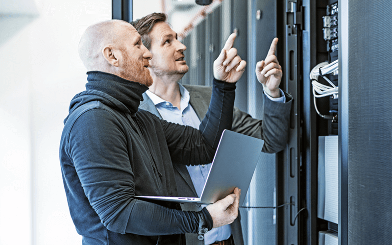 Two male IT workers in server room