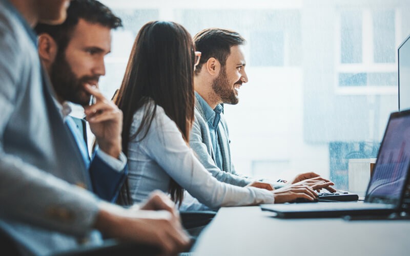 IAM protocols with an Identity as a Service solution by Quest Group of employees smiling