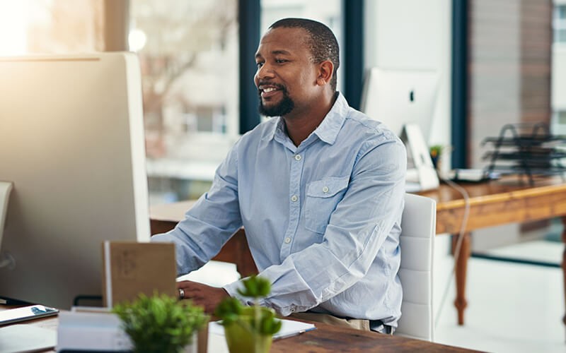 One Identity access and identity management solutions by Quest Business man smiling