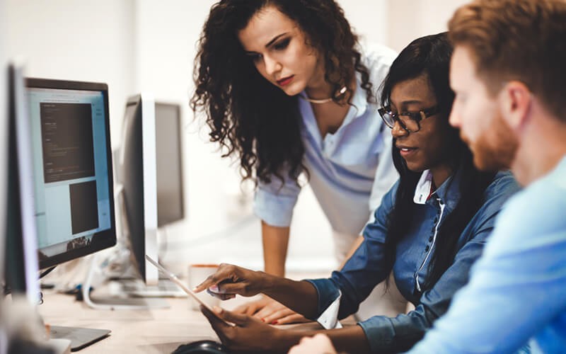 Group of employees working on technology devices