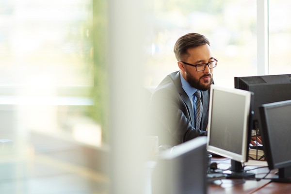 IT administrator using RackWare Management Module software on desktop computer