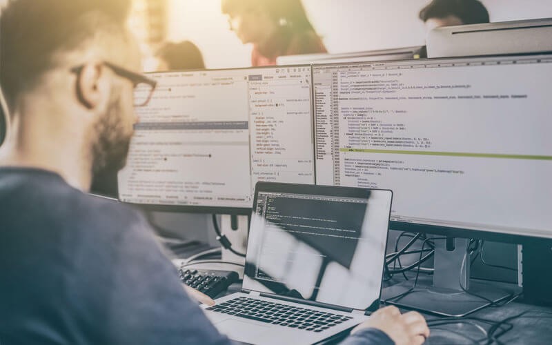 Developer working on computer and coding