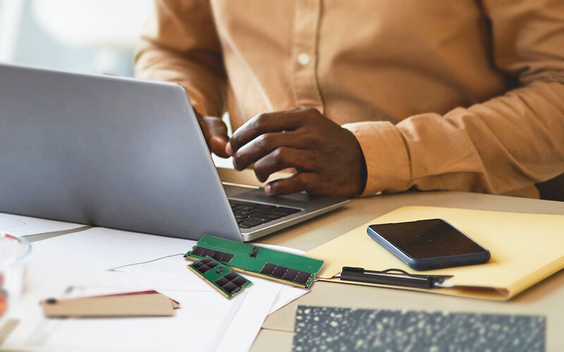 Person using a laptop with a DRAM on the table