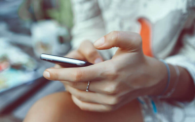 Woman's hands on phone screen