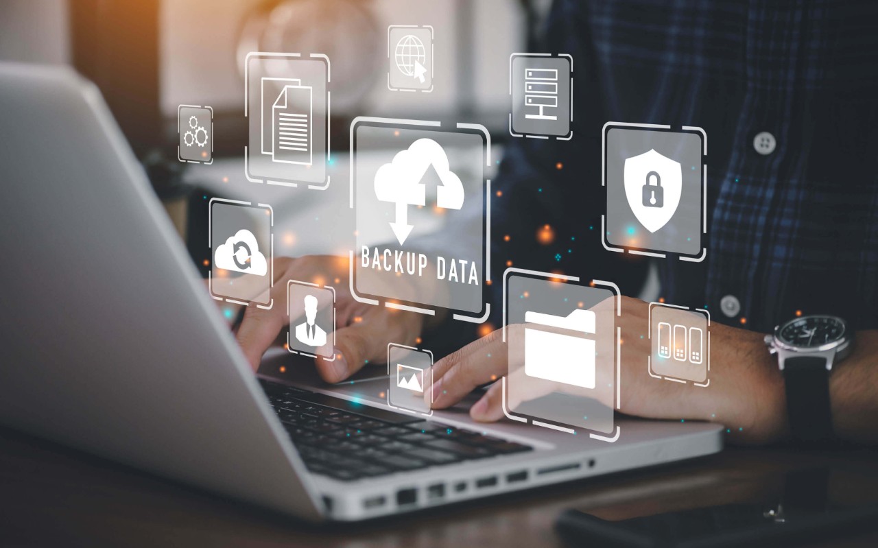 Automated and secure multicloud data management Person using a laptop with security icons