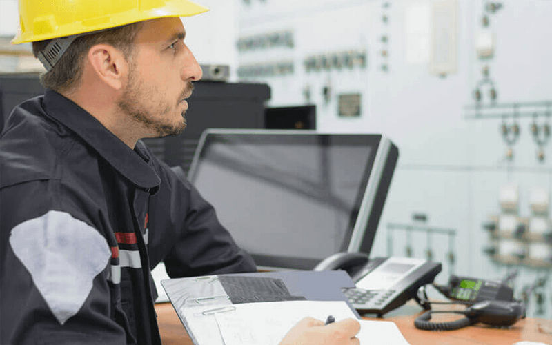 Man with a helmet working at the office