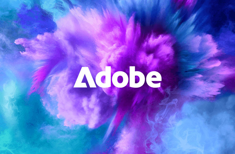 Adobe logo displayed around a cloud of multicolored explosion of powder
