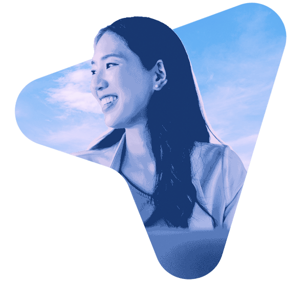 Smiling professional woman seated at an office desk using Insight AI tools to enhance productivity and workflow.