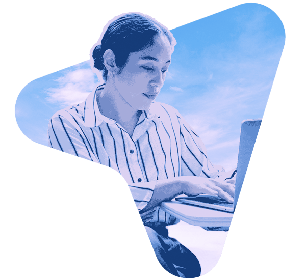 Smiling professional woman seated at an office desk using Insight AI tools to enhance productivity and workflow.
