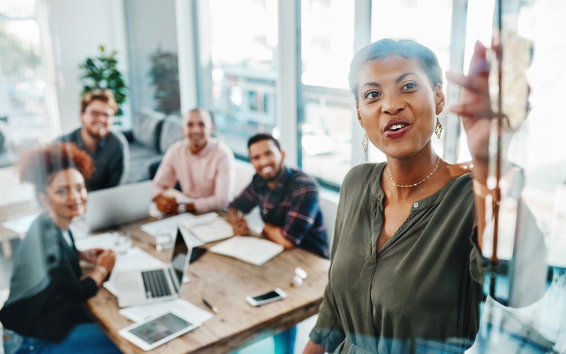 Businesswoman presents project management strategy to team